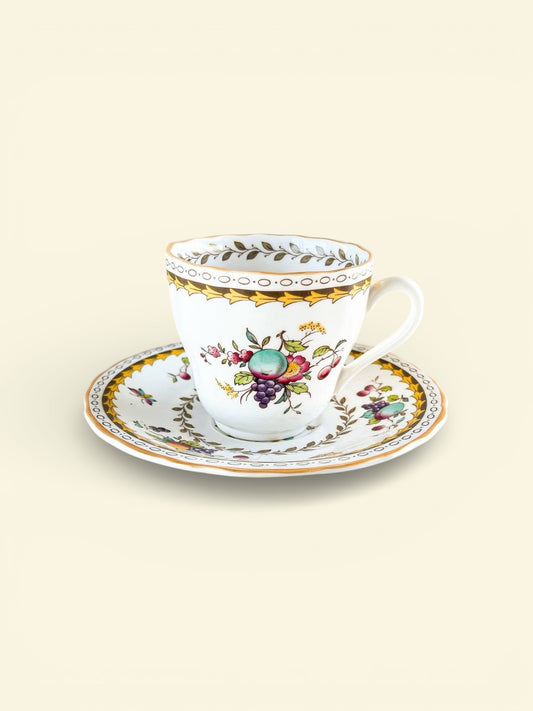 Vintage porcelain teacup and saucer set with floral and fruit motifs and gold trim