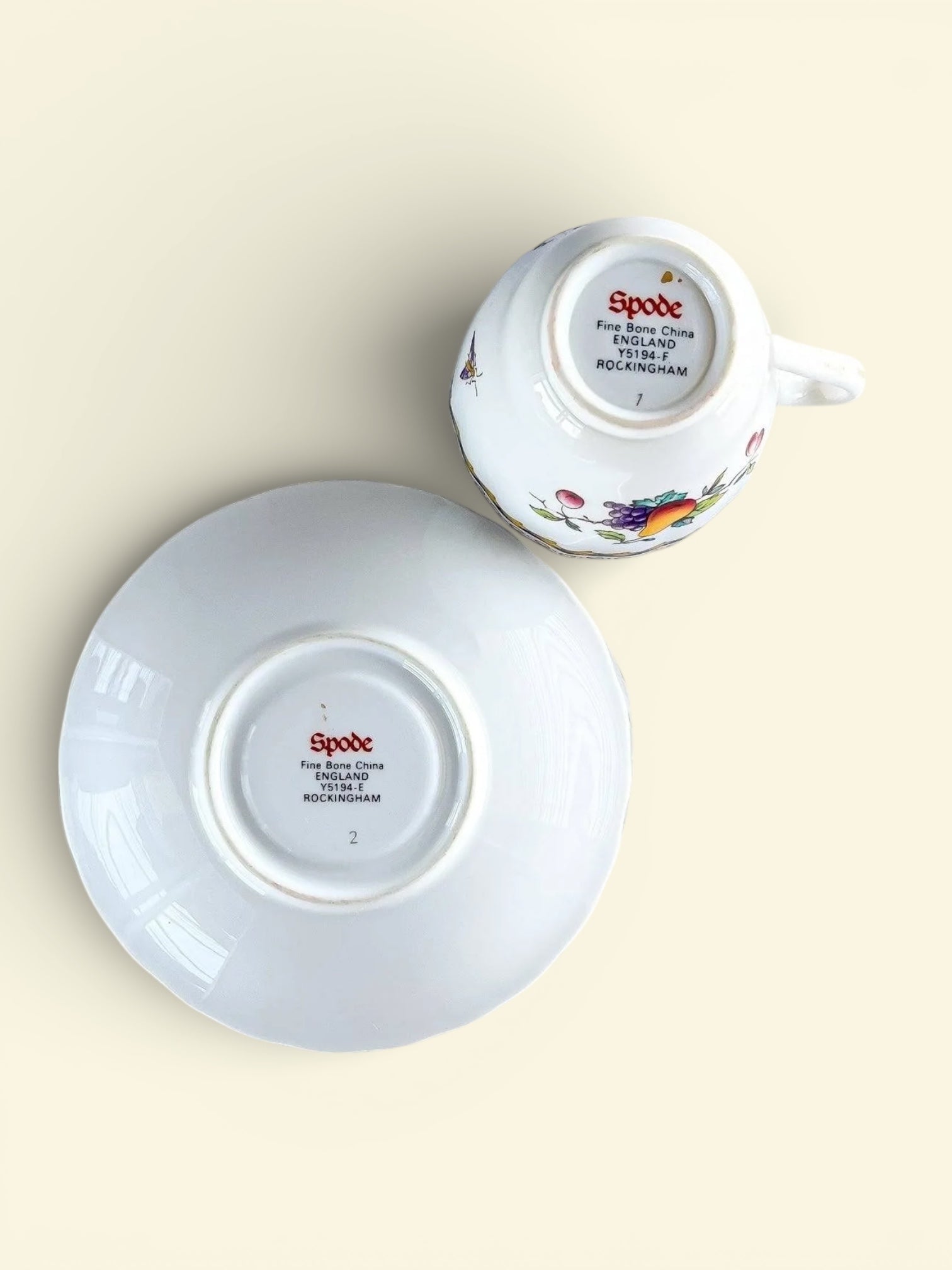Upside down Spode Fine Bone China cup and saucer set with fruit design, Rockingham pattern from England