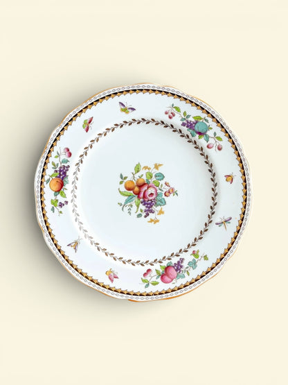 Vintage porcelain plate with floral and fruit patterns, gold and brown leaf border detail