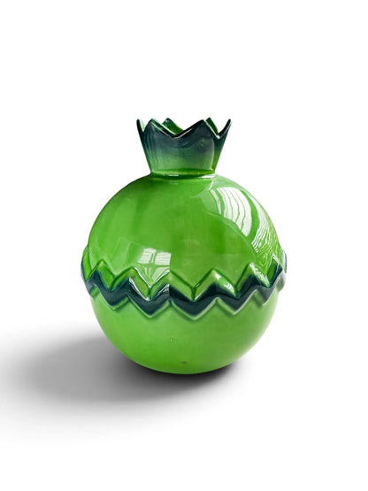 Vintage apple-green ceramic pomegranate vase with a sepal crown mouth and a dark green zigzag band, shown from the side on a white background.