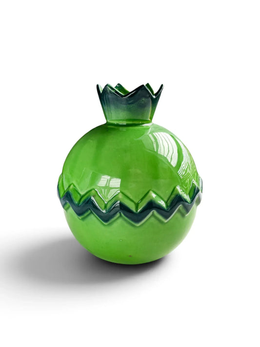 Vintage apple-green ceramic pomegranate vase with a sepal crown mouth and a dark green zigzag band, shown from the side on a white background.