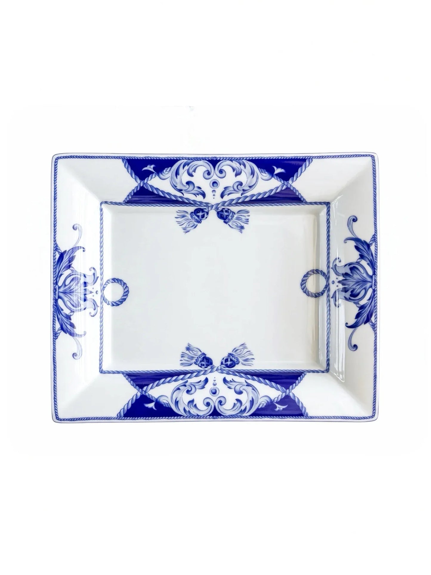 Vista Alegre Villa rectangular porcelain serving dish in cobalt blue and white, overhead view, rope tassels and corner scrolls on a white background.
