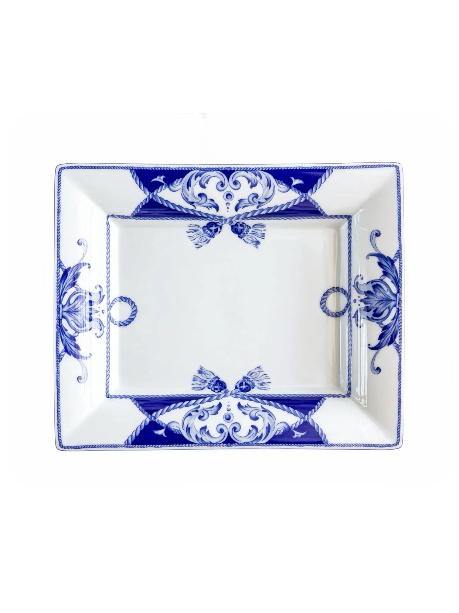 Vista Alegre Villa rectangular porcelain serving dish in cobalt blue and white, overhead view, rope tassels and corner scrolls on a white background.