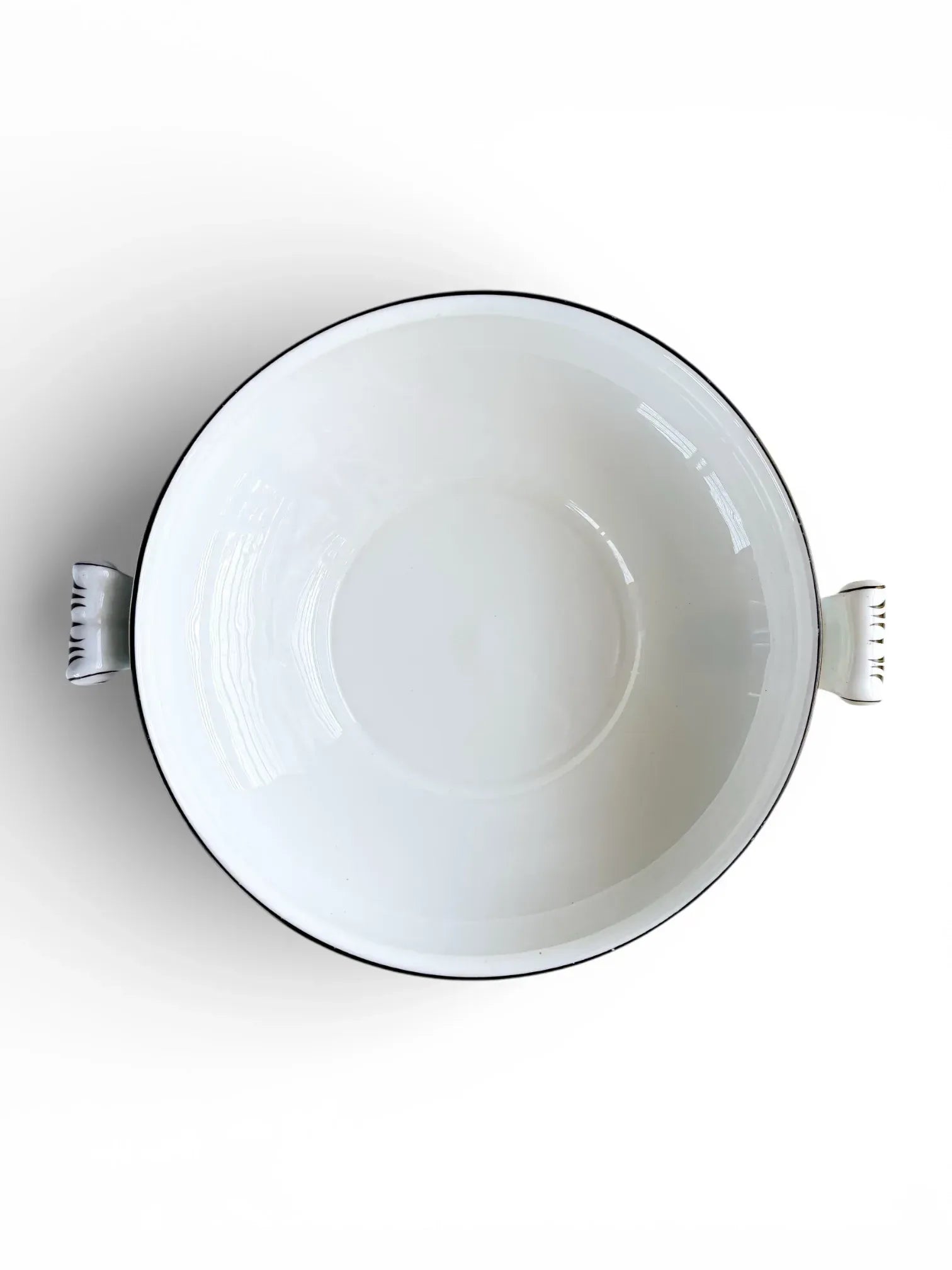 Clean white bone china interior of a Wedgwood Florentine Turquoise vegetable serving bowl.