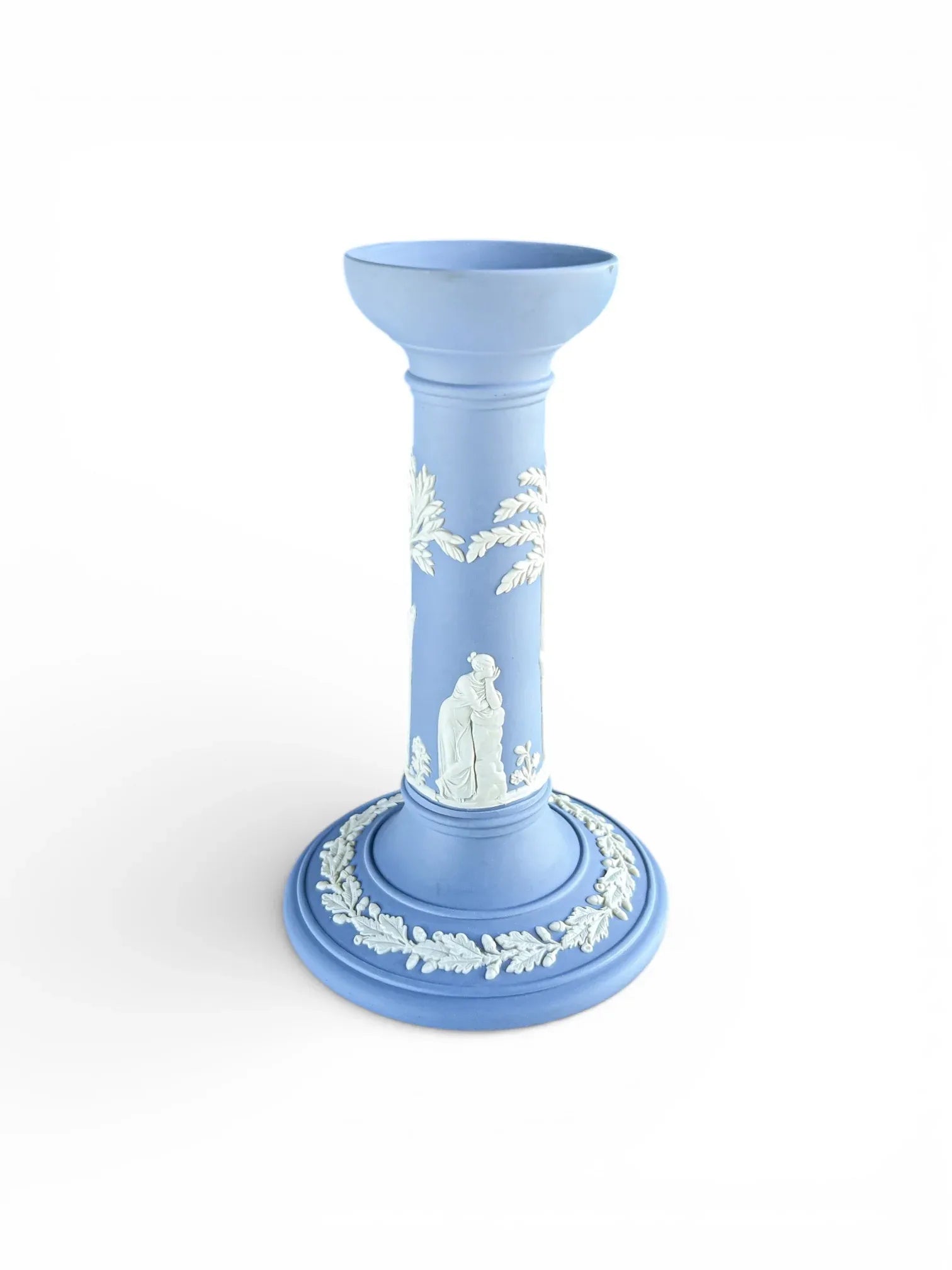 Blue porcelain candlestick with white neoclassical relief, vintage tableware on white background