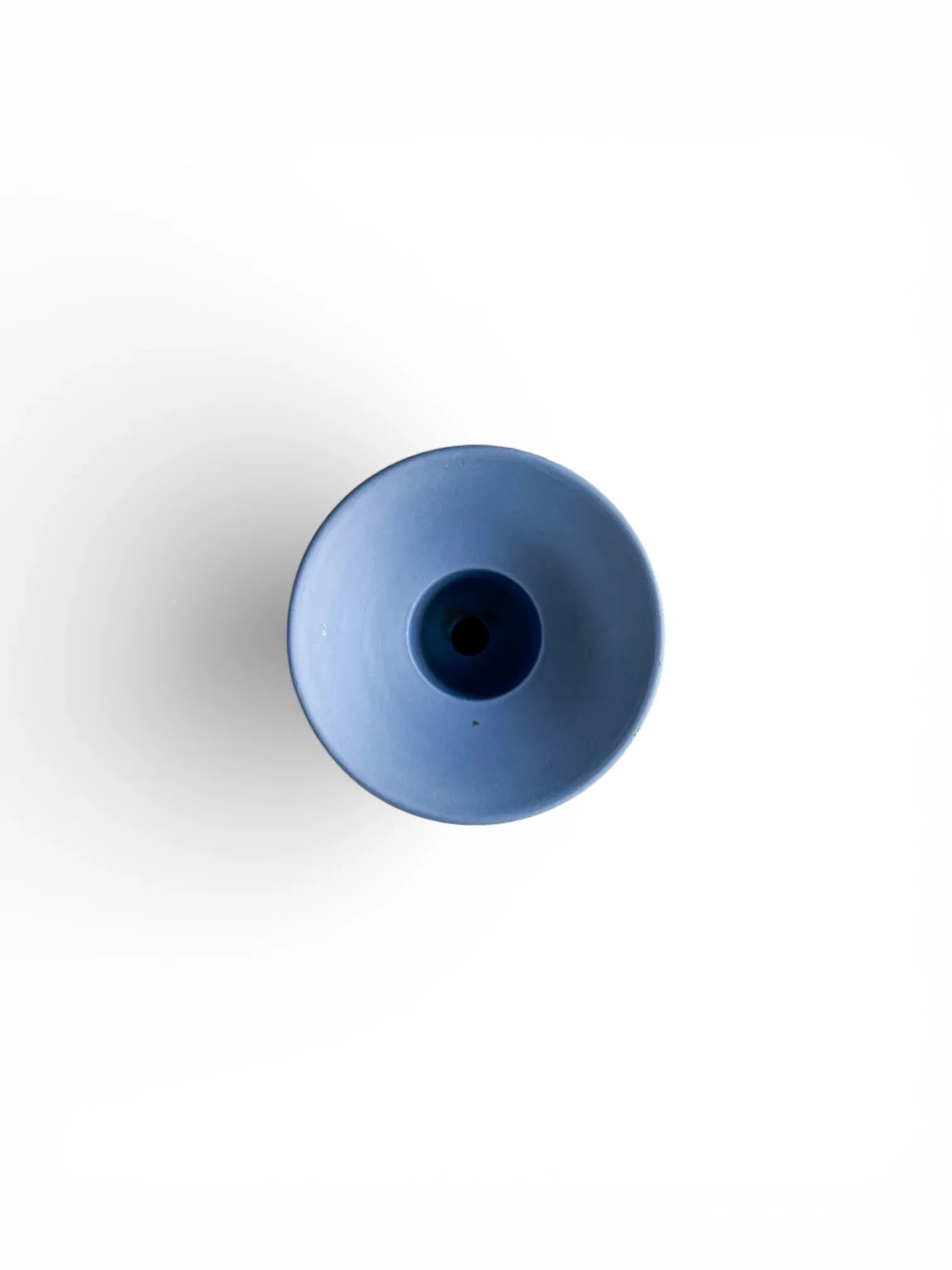 Minimalist blue porcelain vase on white background, modern tableware decor