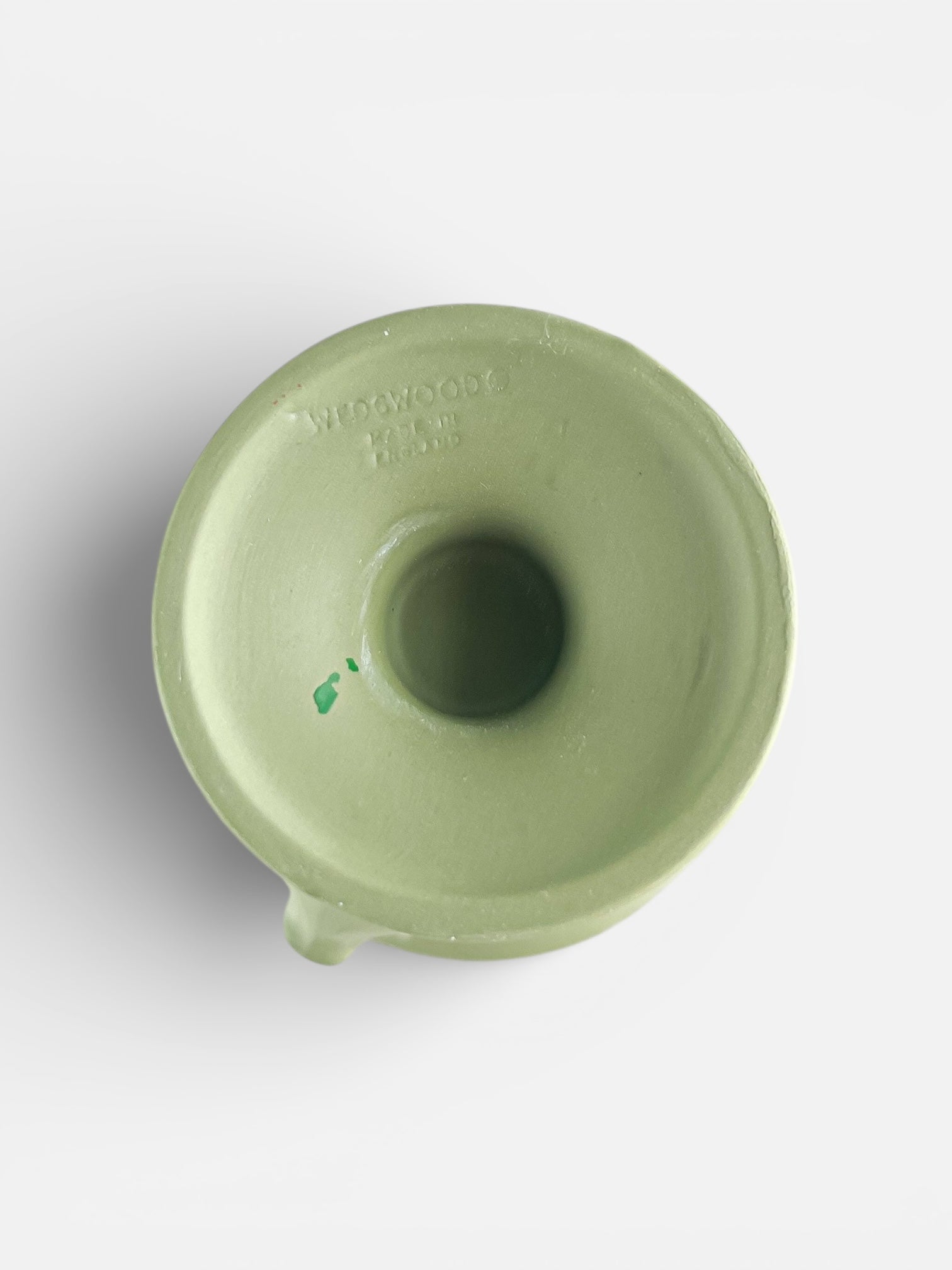 Top view of a green Wedgwood ceramic piece with embossed logo and central hollow opening