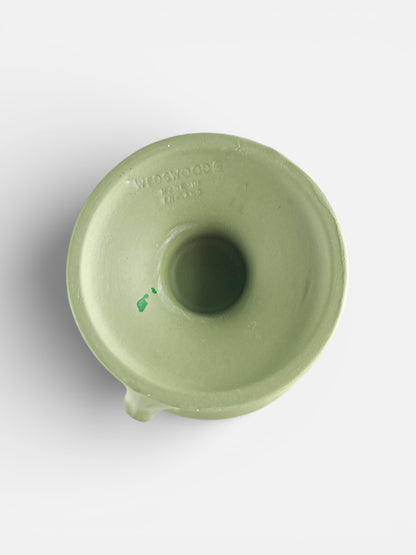 Top view of a green Wedgwood ceramic piece with embossed logo and central hollow opening