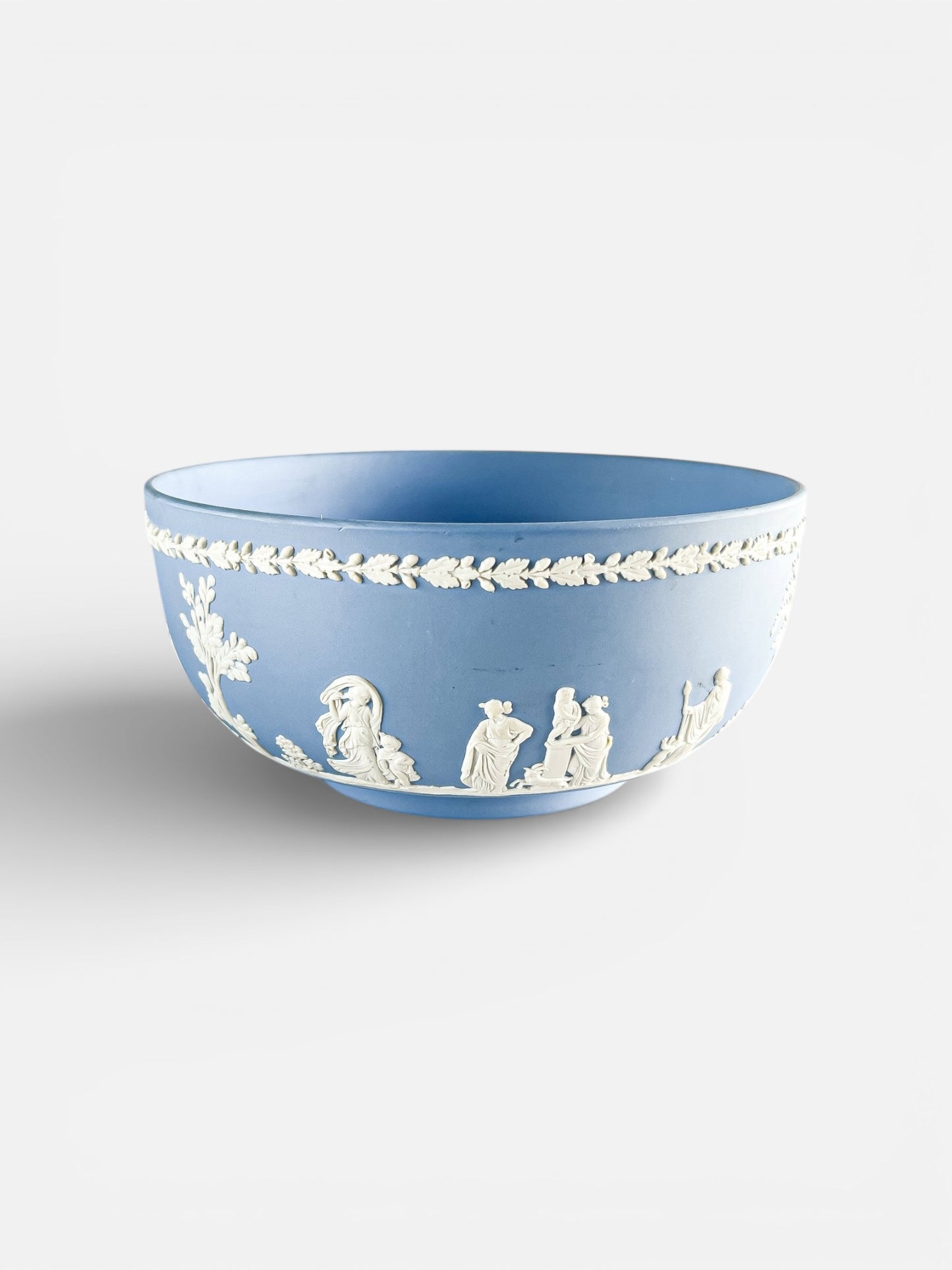 Blue Wedgwood-style ceramic bowl with white classical relief figures and decorative leaf border