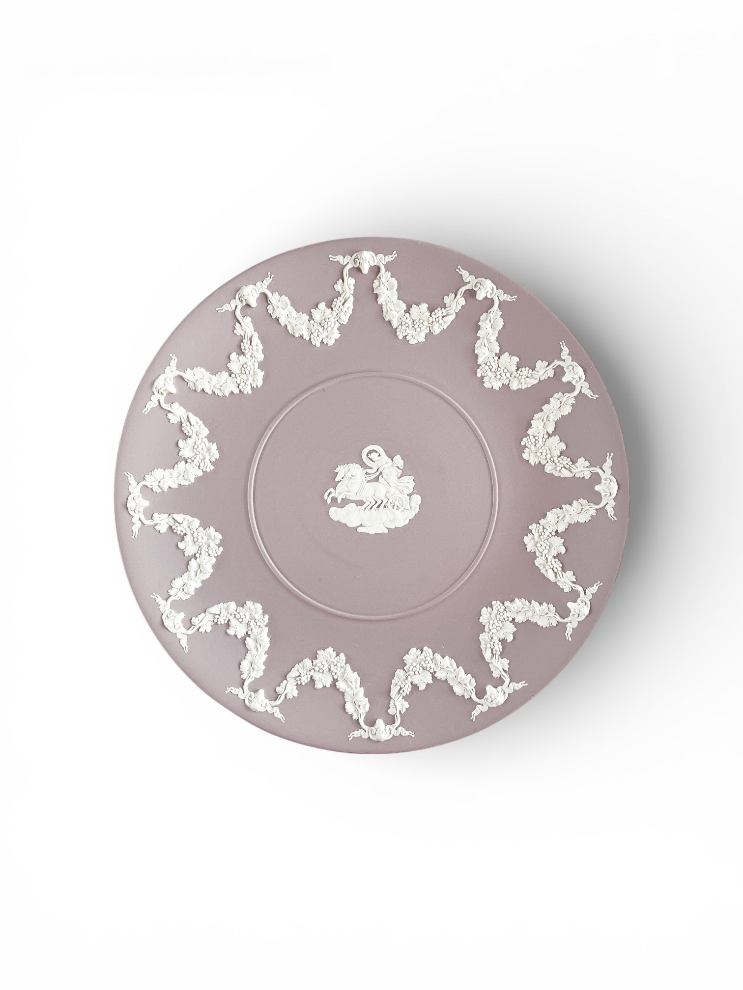 Decorative vintage mauve porcelain plate with white floral garland and chariot design
