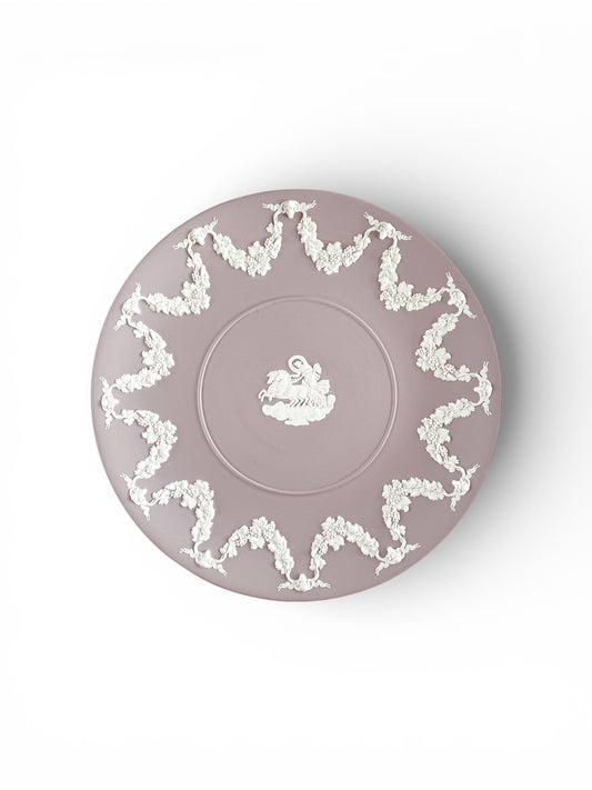 Decorative vintage mauve porcelain plate with white floral garland and chariot design