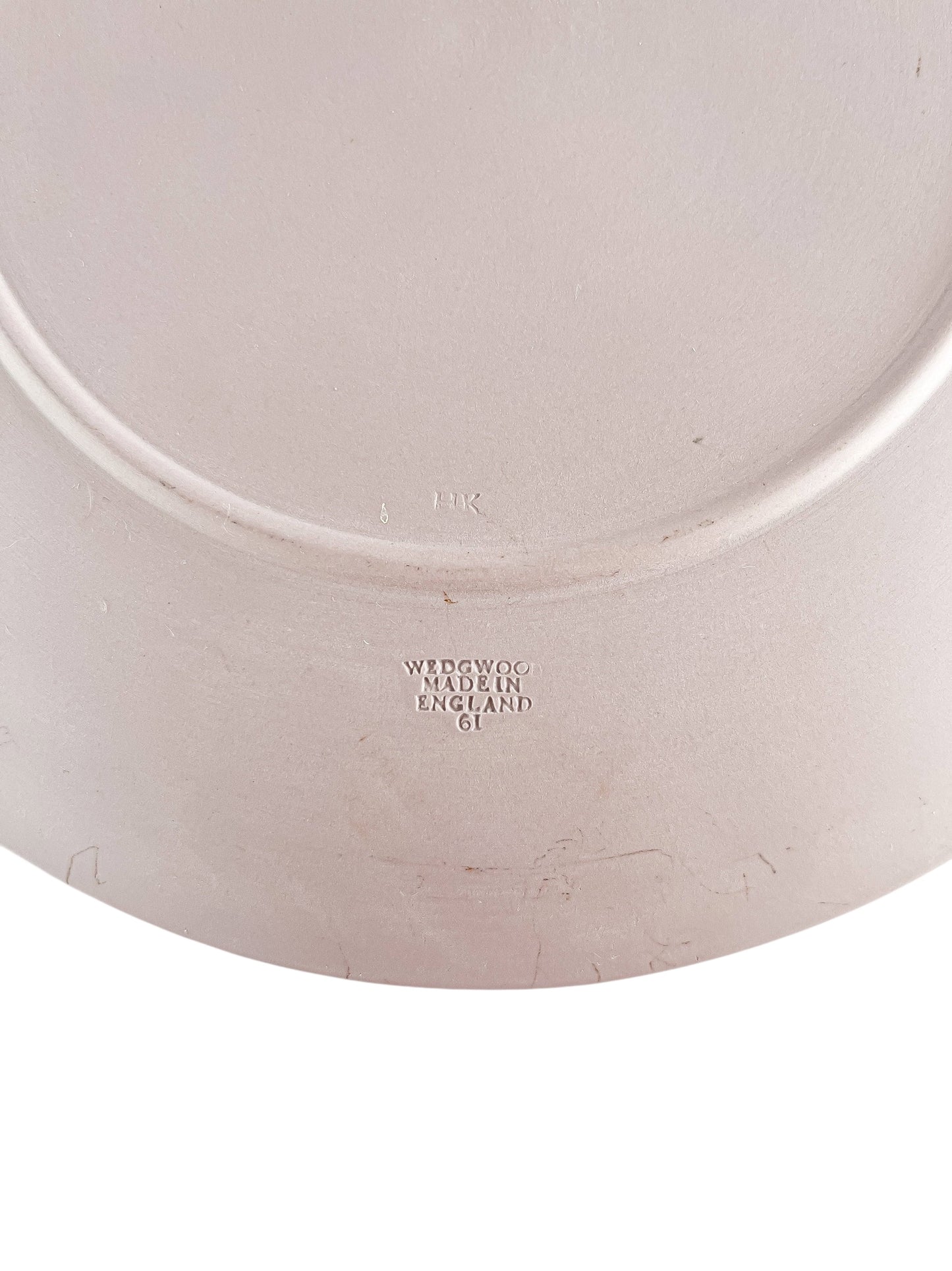 Close-up of Wedgwood pottery mark on vintage plate made in England, embossed with '61' and 'HK'