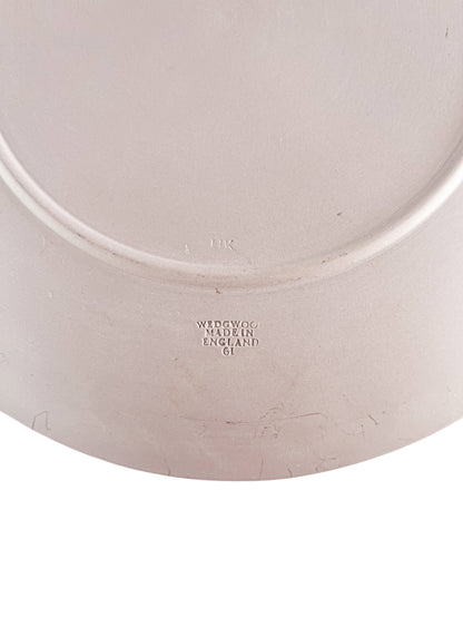 Close-up of Wedgwood pottery mark on vintage plate made in England, embossed with '61' and 'HK'