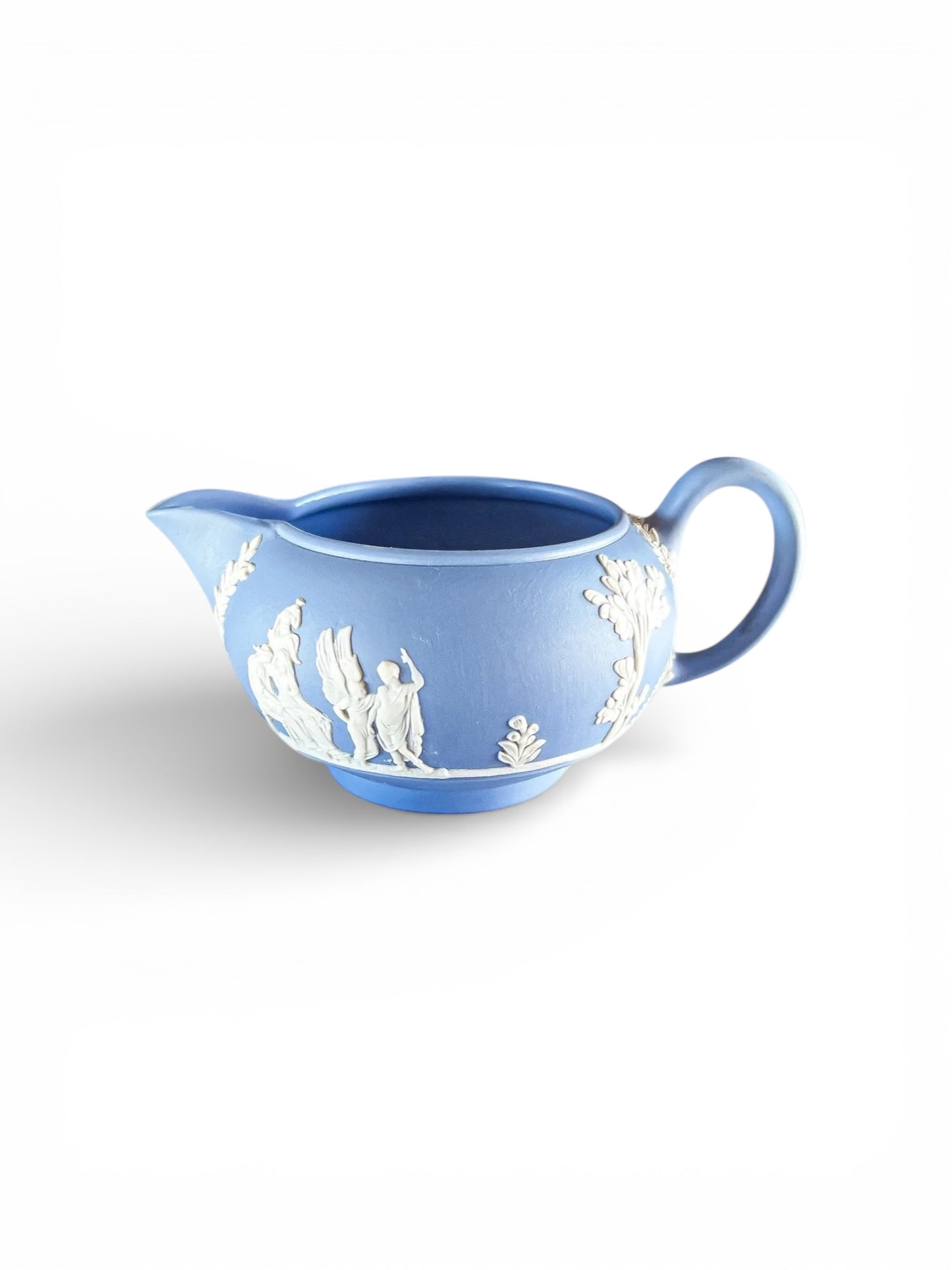 Blue Jasperware ceramic creamer with white classical relief figures and floral details