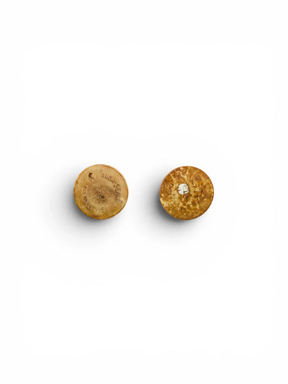 Flat lay view of the undersides of two vintage Suba-Seal rubber stoppers for the shakers, showing authentic age-related texture, crackling, and partial branding marks on the aged brown rubber.