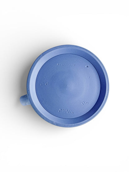 Bottom view of a Wedgwood pale blue jasperware jug with embossed markings on white background