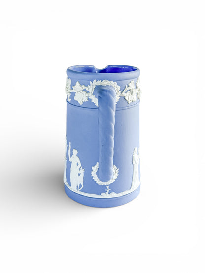 Blue Jasperware porcelain mug with twisted handle and white classical relief decorations