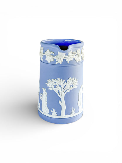 Blue Jasperware jug with white classical reliefs of figures and tree, decorative grapevine border