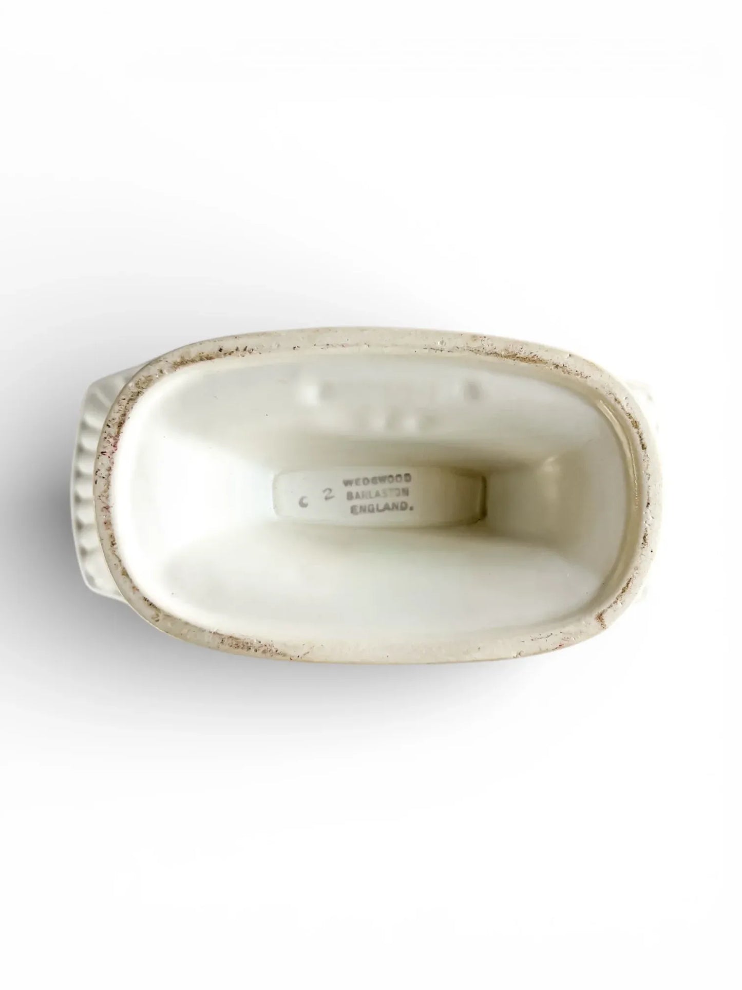 Top view of a vintage Wedgwood England white porcelain dish with embossed details