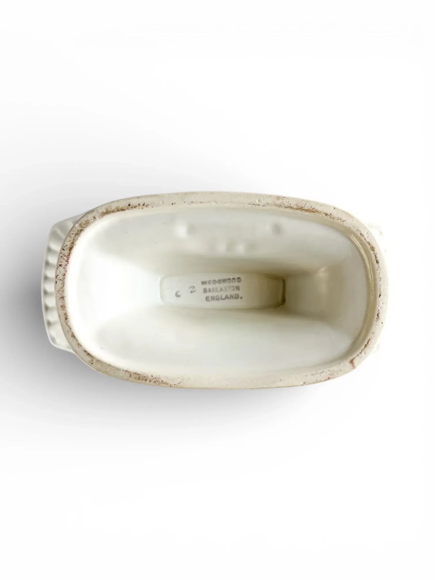 Top view of a vintage Wedgwood England white porcelain dish with embossed details