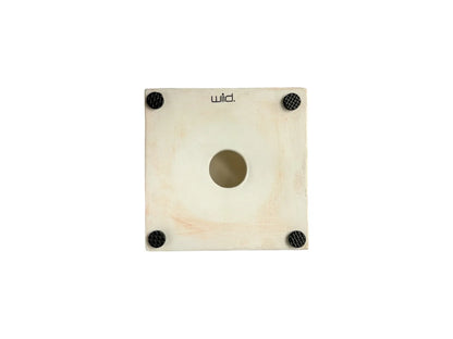 The underside of a square ceramic tile, showing a matte white coloured clay body. The "wiid." maker's mark is stamped at the top, and four black non-slip rubber feet are attached to the corners, with a circular mounting hole in the centre.