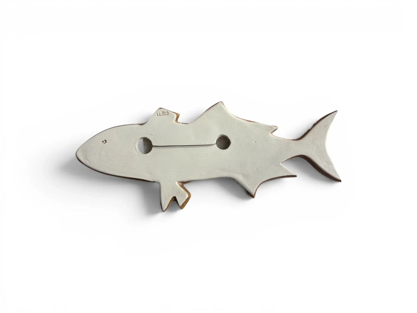 The reverse side of a Wiid Design ceramic fish, showing the flat, unglazed white earthenware surface. It features the 'Wiid' studio hallmark and an integrated wire for secure wall mounting.