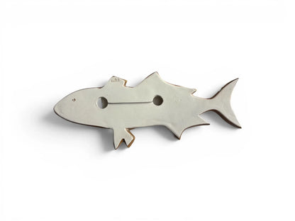 The reverse side of a Wiid Design ceramic fish, showing the flat, unglazed white earthenware surface. It features the 'Wiid' studio hallmark and an integrated wire for secure wall mounting.
