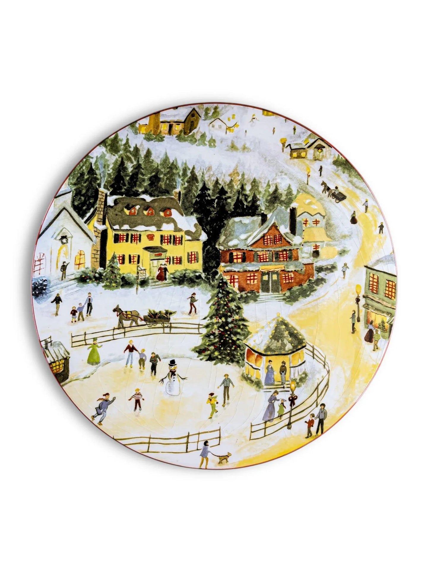 Decorative plate featuring a snowy village scene with ice skating, Christmas tree, cottages, and people in winter attire