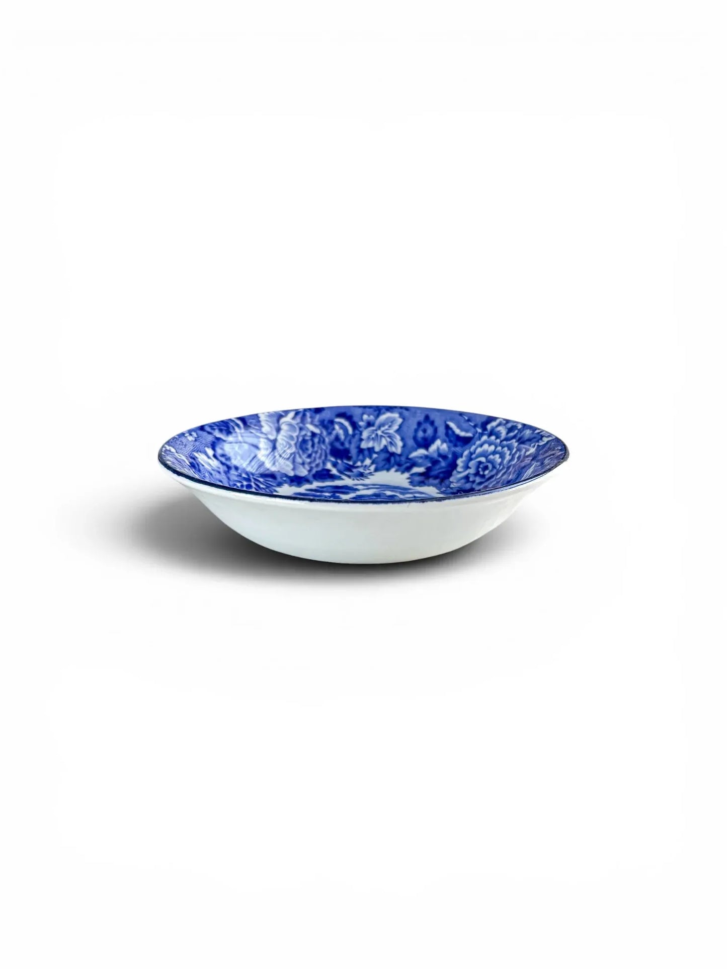 Profile view of a Wood & Sons 'English Scenery' blue and white bowl, showing its shallow, elegant form and clean white exterior.