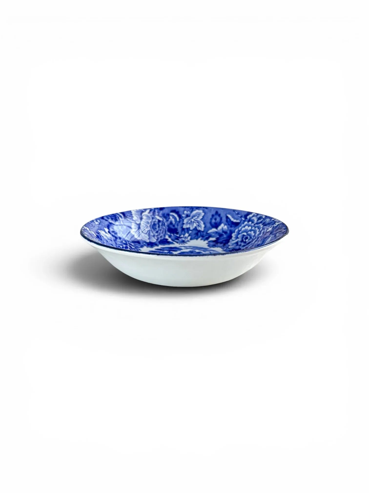 Profile view of a Wood & Sons 'English Scenery' blue and white bowl, showing its shallow, elegant form and clean white exterior.